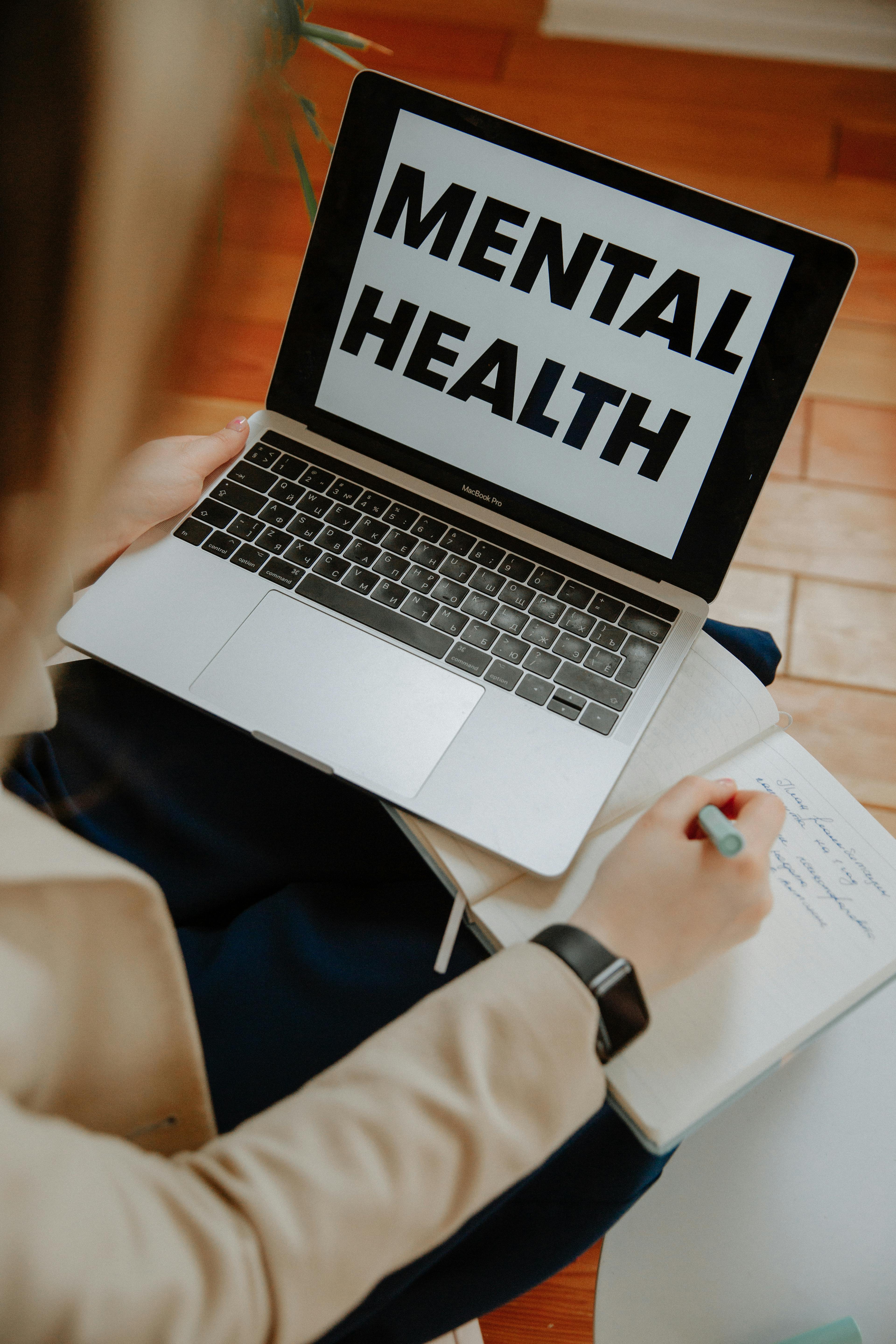 Laptop with 'Mental Health' label representing online therapy and support