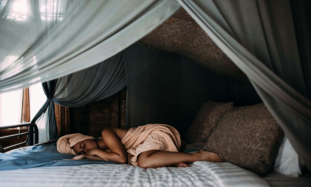 Individual struggling with sleep due to stress and racing thoughts, seeking help for better sleep