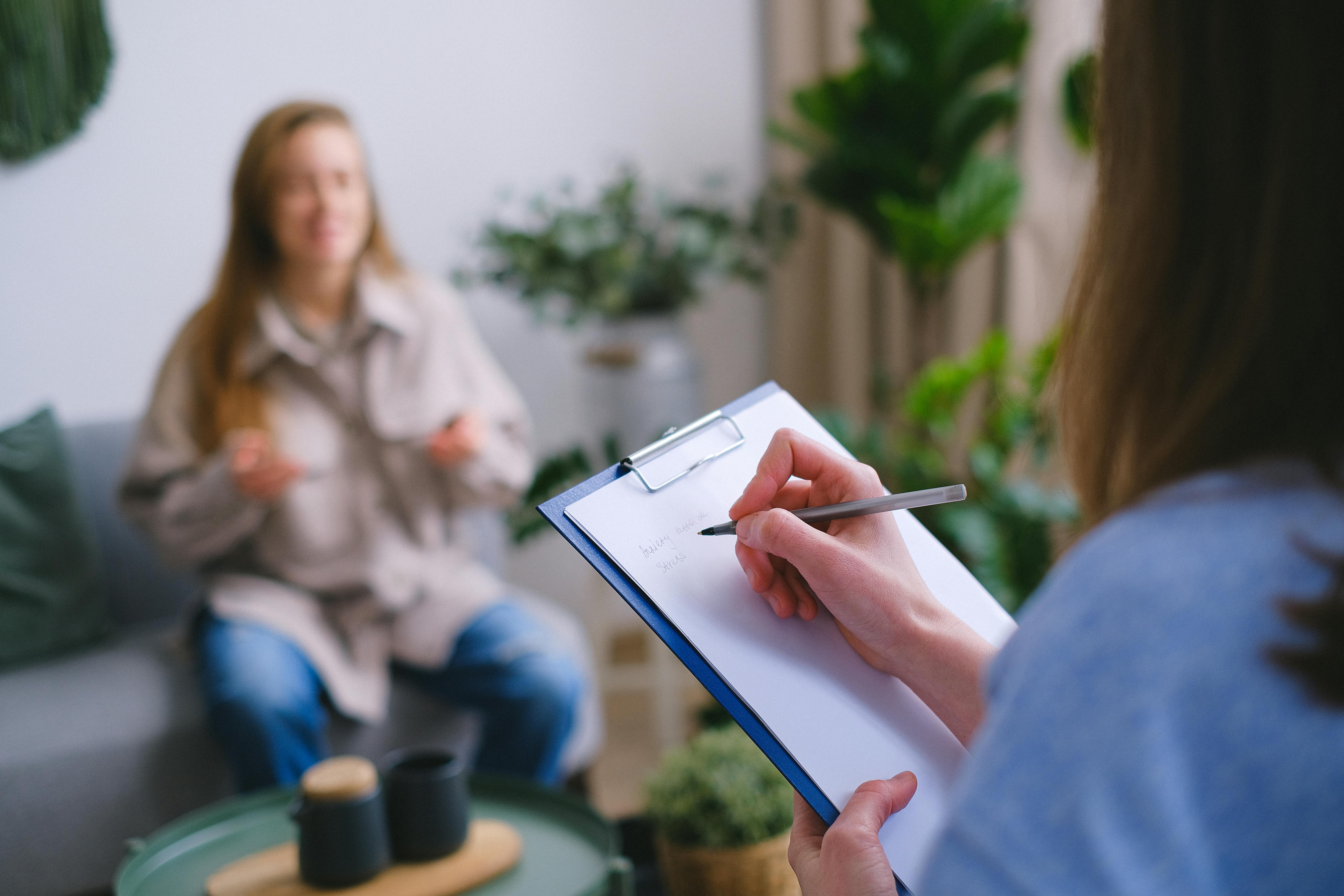 Person feeling overwhelmed by stress and emotional exhaustion seeking therapy for healing